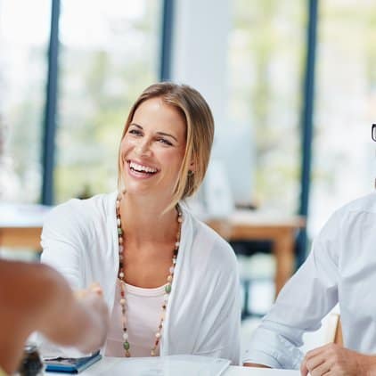 woman and man sitting at table smiling