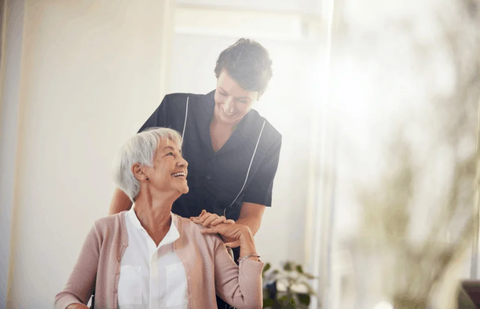 care taker pushing woman in wheelchair