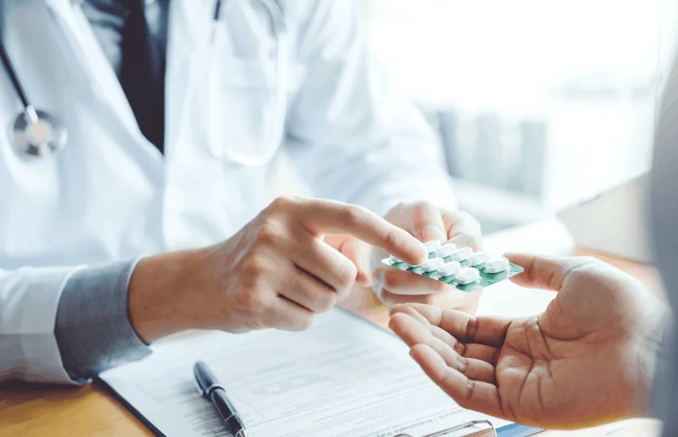 pharmacist holding packet of pills